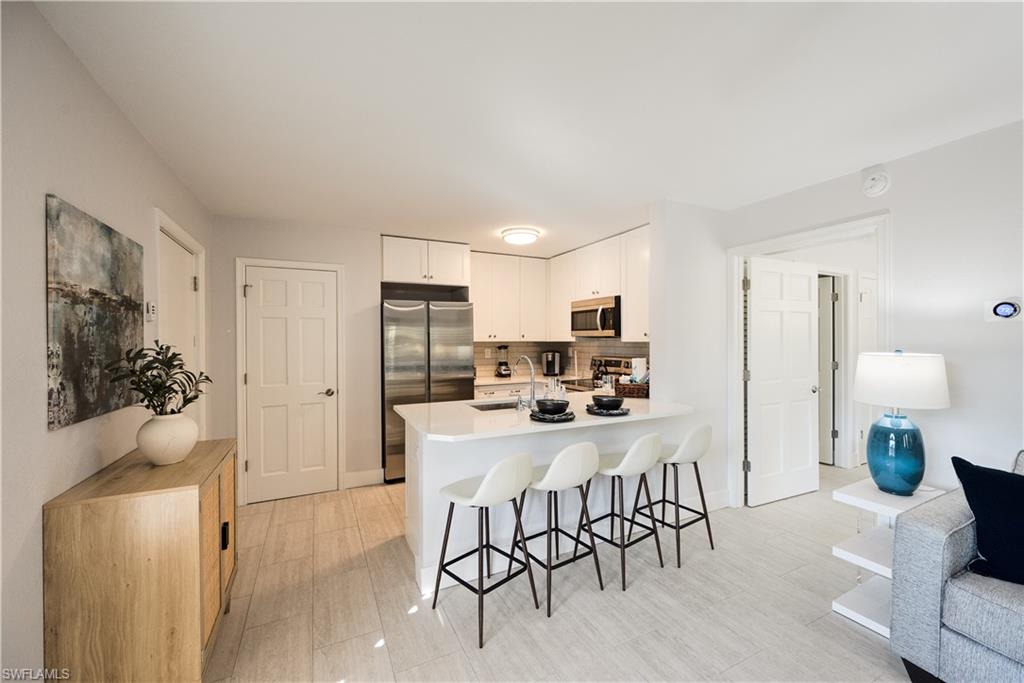 655 8th Avenue South, Unit 3 Naples, FL 34102 - Photo 1 of 48 a view of a dining room with furniture and wooden floor