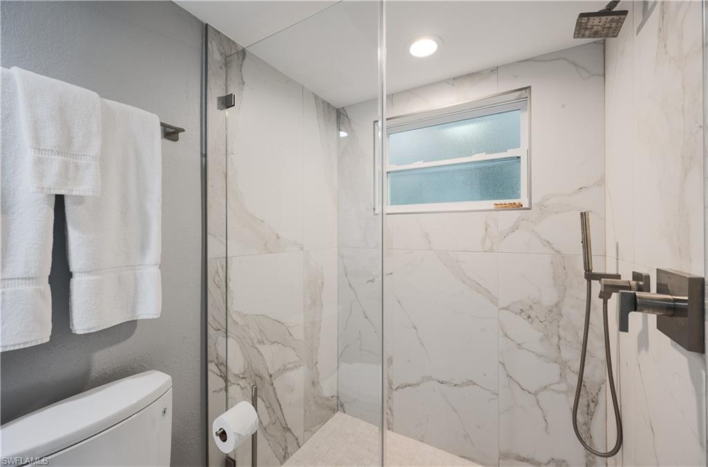 655 8th Avenue South, Unit 3 Naples, FL 34102 - Photo 11 of 48 a bathroom with a shower and toilet