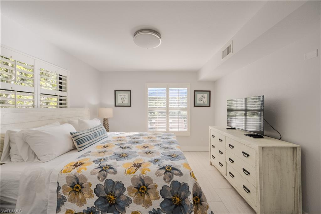 655 8th Avenue South, Unit 3 Naples, FL 34102 - Photo 22 of 48 a bedroom with a bed and a window