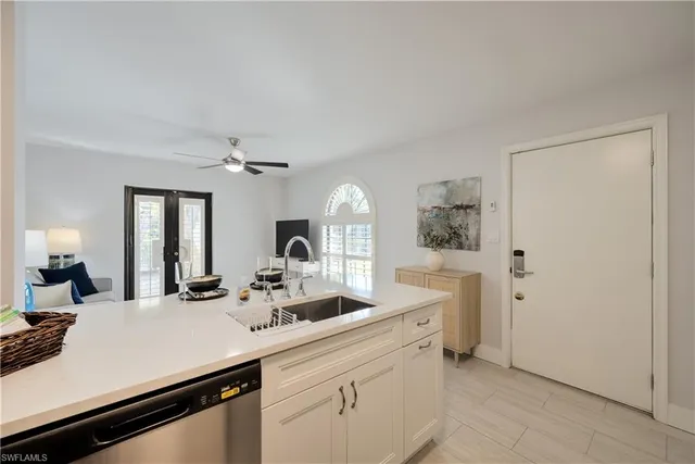 a view of a sink and a refrigerator a mirror