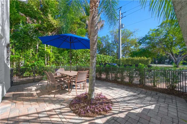 a view of a patio with table and chairs potted plants with wooden fence