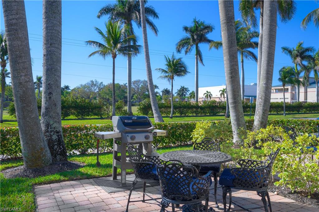 655 8th Avenue South, Unit 3 Naples, FL 34102 - Photo 30 of 48 a view of a chairs and table in backyard of a house