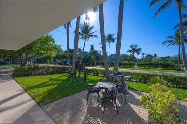 a view of a table and chairs in patio with a yard