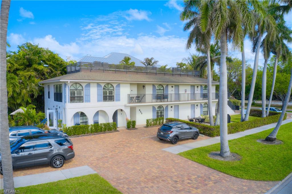 655 8th Avenue South, Unit 3 Naples, FL 34102 - Photo 37 of 48 a front view of a house with garden