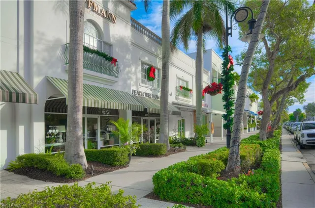 a view of a brick house with a yard and plants