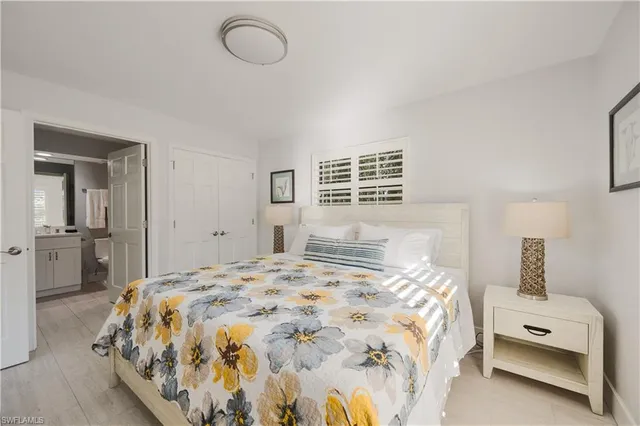 a bedroom with a bed and dresser with mirror