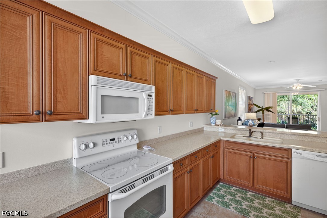 8251 Pathfinder Loop, Unit 621 Fort Myers, FL 33919 - Photo 7 of 30 a kitchen with a sink stove top oven and cabinets