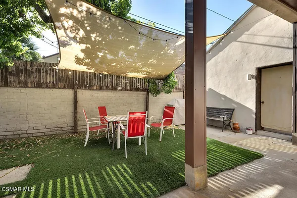 an aerial view of a house with swimming pool and sitting area