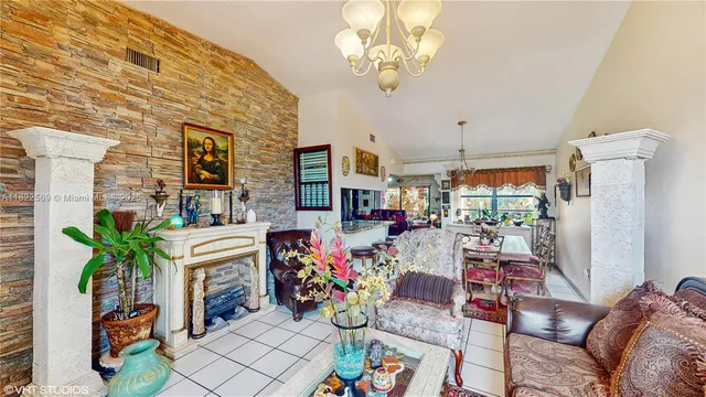 a living room with patio furniture and a fireplace