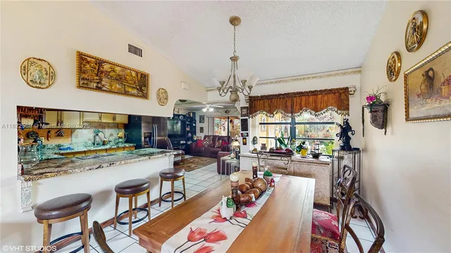 a view of a dining room with furniture and a chandelier