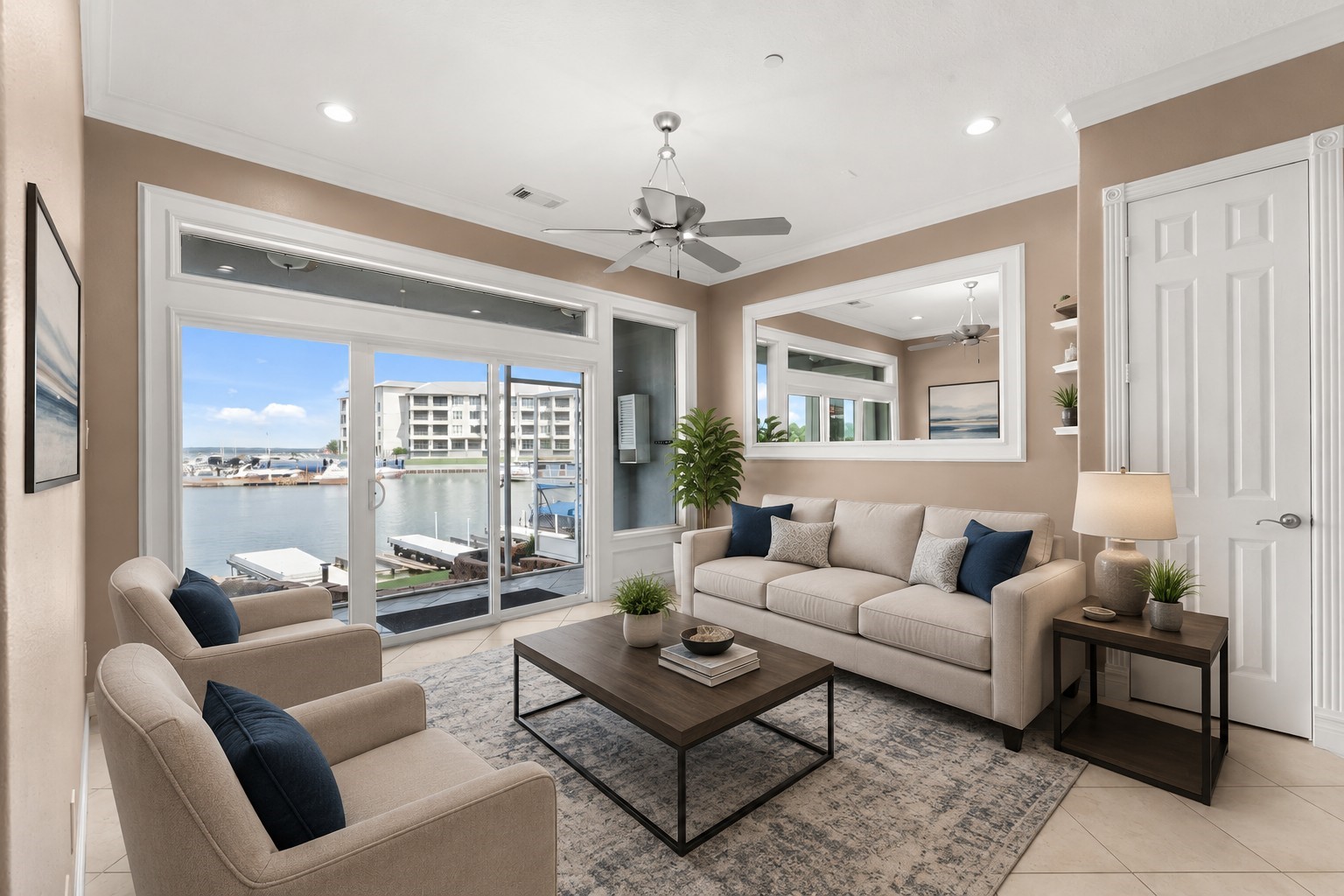 168 Lake Point Boulevard, Unit C102 Conroe, TX 77356 - Photo 1 of 35 Virtually staged, this inviting living room offers stunning waterfront views through expansive glass doors, creating a serene and stylish space perfect for relaxation and entertainment.