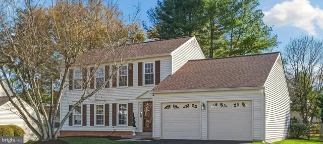 a kitchen with stainless steel appliances granite countertop a refrigerator a stove a sink and a microwave