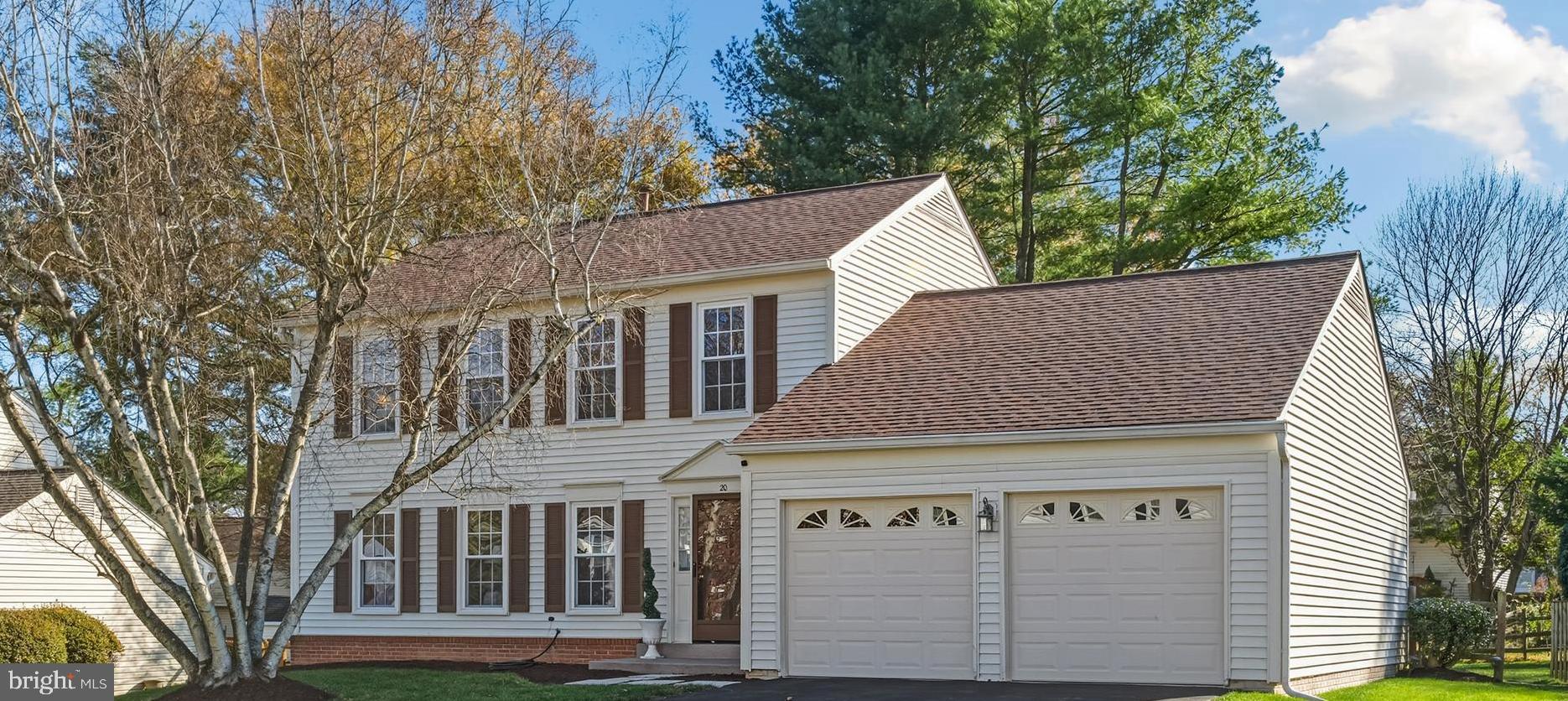 20 Allenhurst Court Gaithersburg, MD 20878 - Photo 16 of 57 a view of a white house with large windows and a small yard