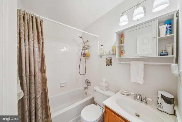 a gym room with furniture and a flat screen tv