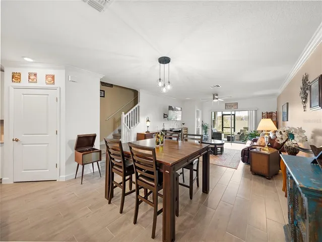 a view of a dining room with furniture and chandelier