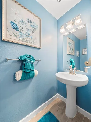 a bathroom with a sink mirror and vanity