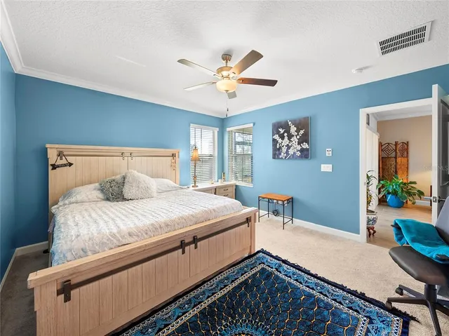 a bedroom with bed and a chandelier
