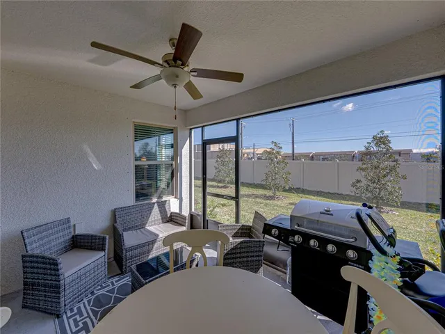 a living room with furniture and a floor to ceiling window