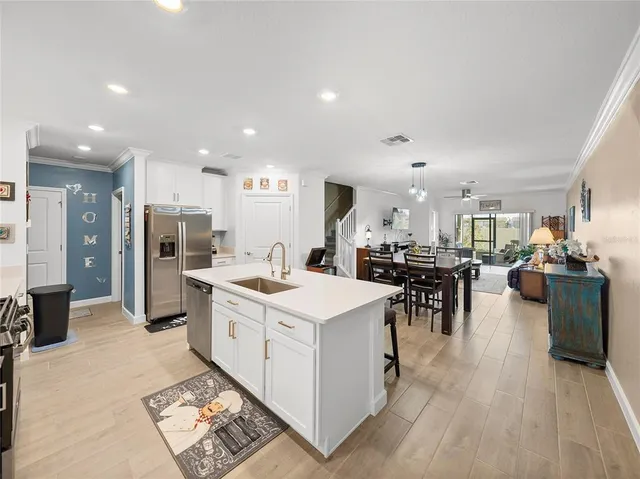 a large kitchen with a large counter top appliances and cabinets