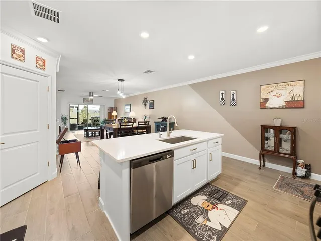 a kitchen that has a lot of cabinets a sink and a stove in it