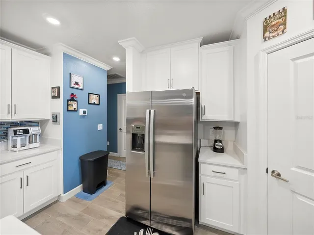 a kitchen with stainless steel appliances a refrigerator sink and cabinets
