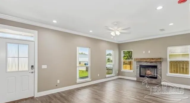 a view of an empty room with a fireplace and a window