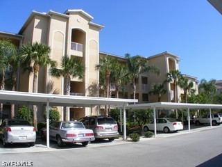 3780 Sawgrass Way, Unit 3346 Naples, FL 34112 - Photo 2 of 8 a view of a car parked in front of a building