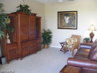 3780 Sawgrass Way, Unit 3346 Naples, FL 34112 - Photo 3 of 8 a living room with furniture cabinets and a potted plant