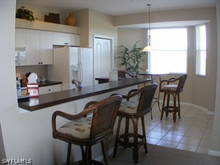 3780 Sawgrass Way, Unit 3346 Naples, FL 34112 - Photo 4 of 8 a dining room with furniture and window