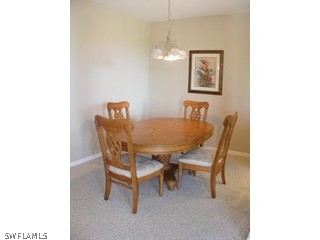 3780 Sawgrass Way, Unit 3346 Naples, FL 34112 - Photo 5 of 8 a dining room with furniture and window