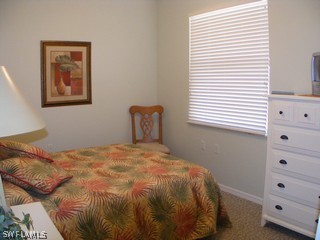 3780 Sawgrass Way, Unit 3346 Naples, FL 34112 - Photo 7 of 8 a bedroom with a bed and a window