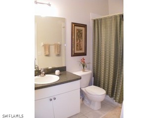 3780 Sawgrass Way, Unit 3346 Naples, FL 34112 - Photo 8 of 8 a bathroom with a toilet a sink and mirror