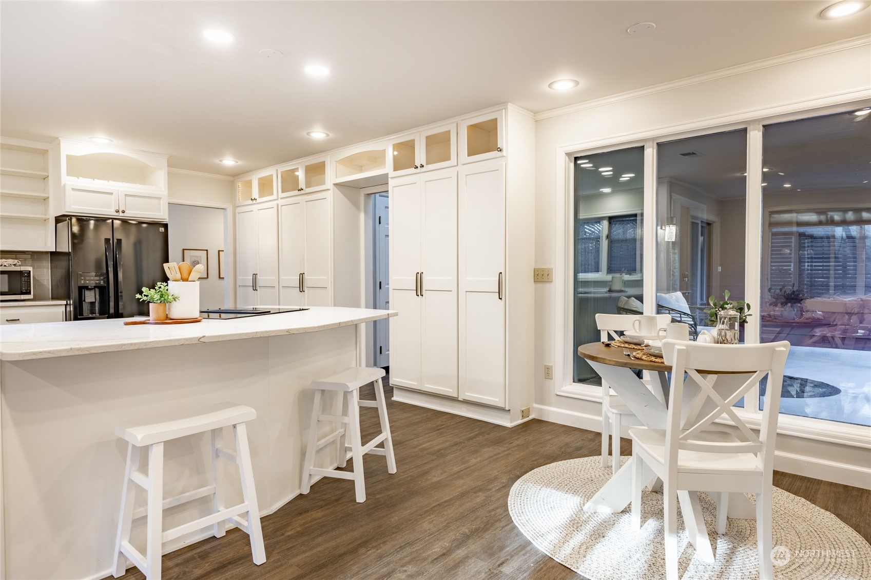 624 Clark Road Bellingham, WA 98225 - Photo 12 of 40 a kitchen with a table chairs refrigerator and cabinets