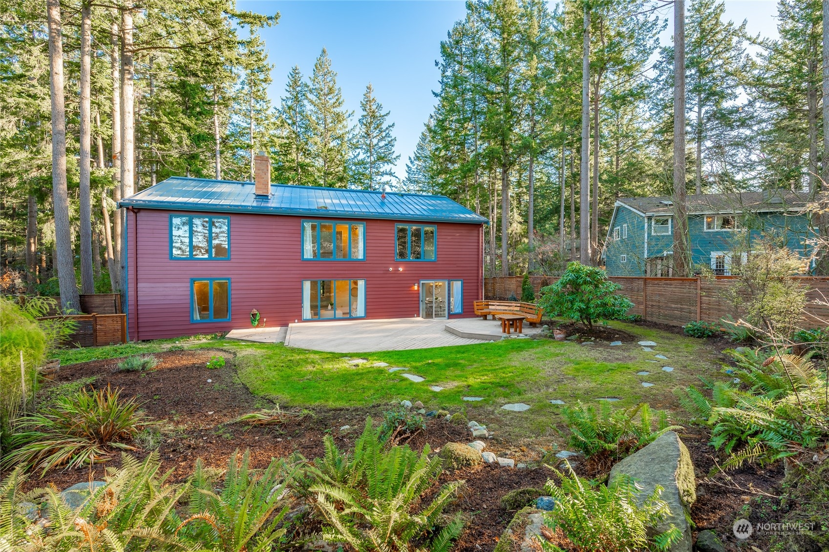 624 Clark Road Bellingham, WA 98225 - Photo 36 of 40 a view of a house with backyard sitting area and garden