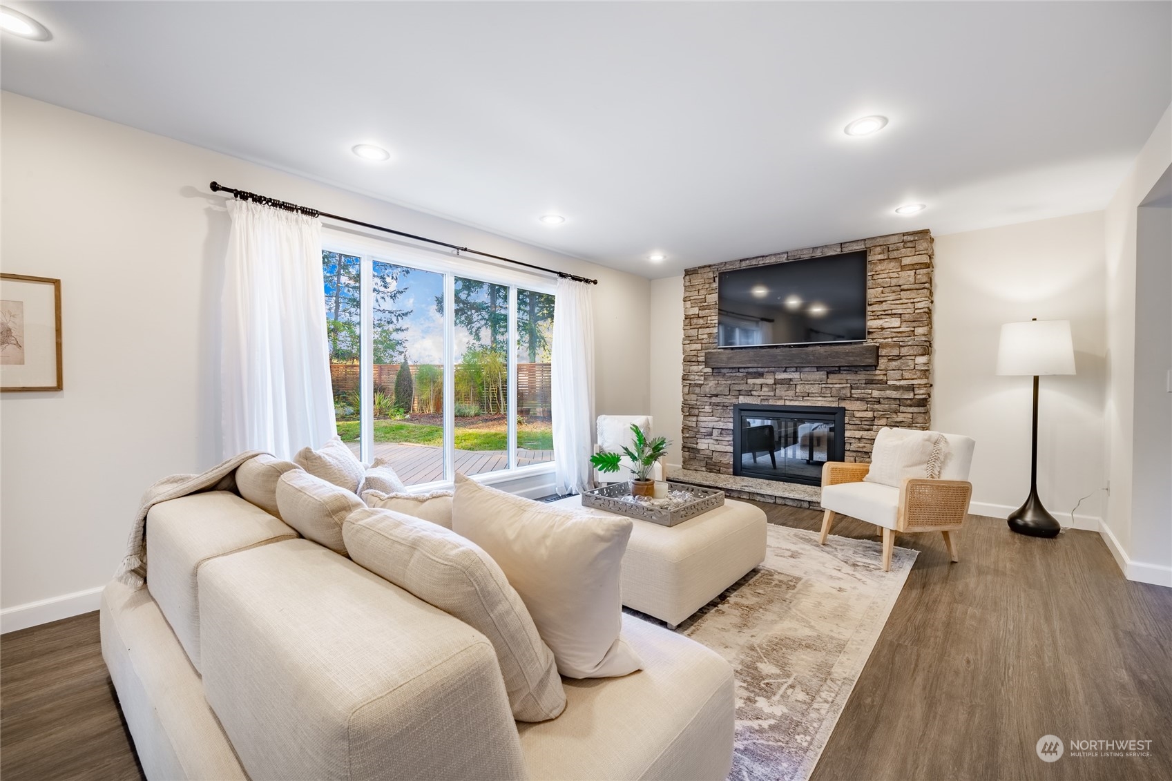 624 Clark Road Bellingham, WA 98225 - Photo 5 of 40 a living room with furniture a large window and a fireplace