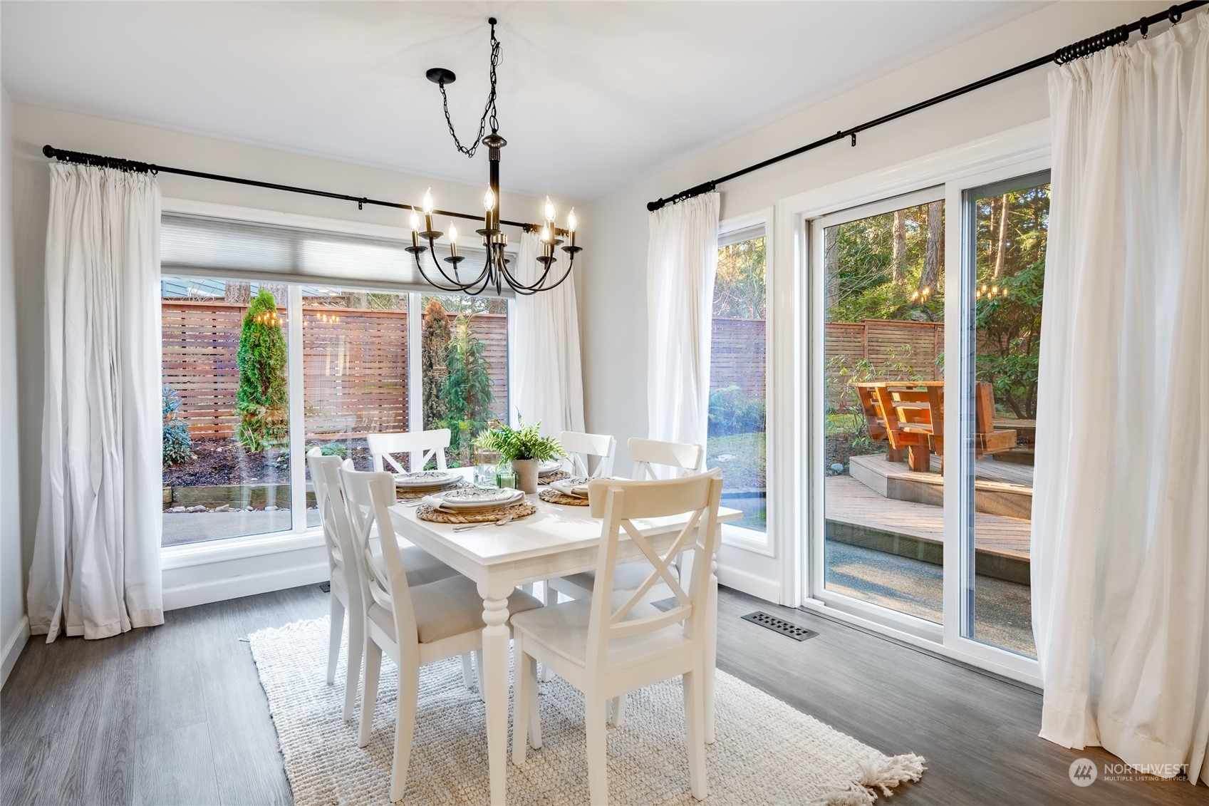 624 Clark Road Bellingham, WA 98225 - Photo 7 of 40 a view of a dining room with furniture large windows and wooden floor