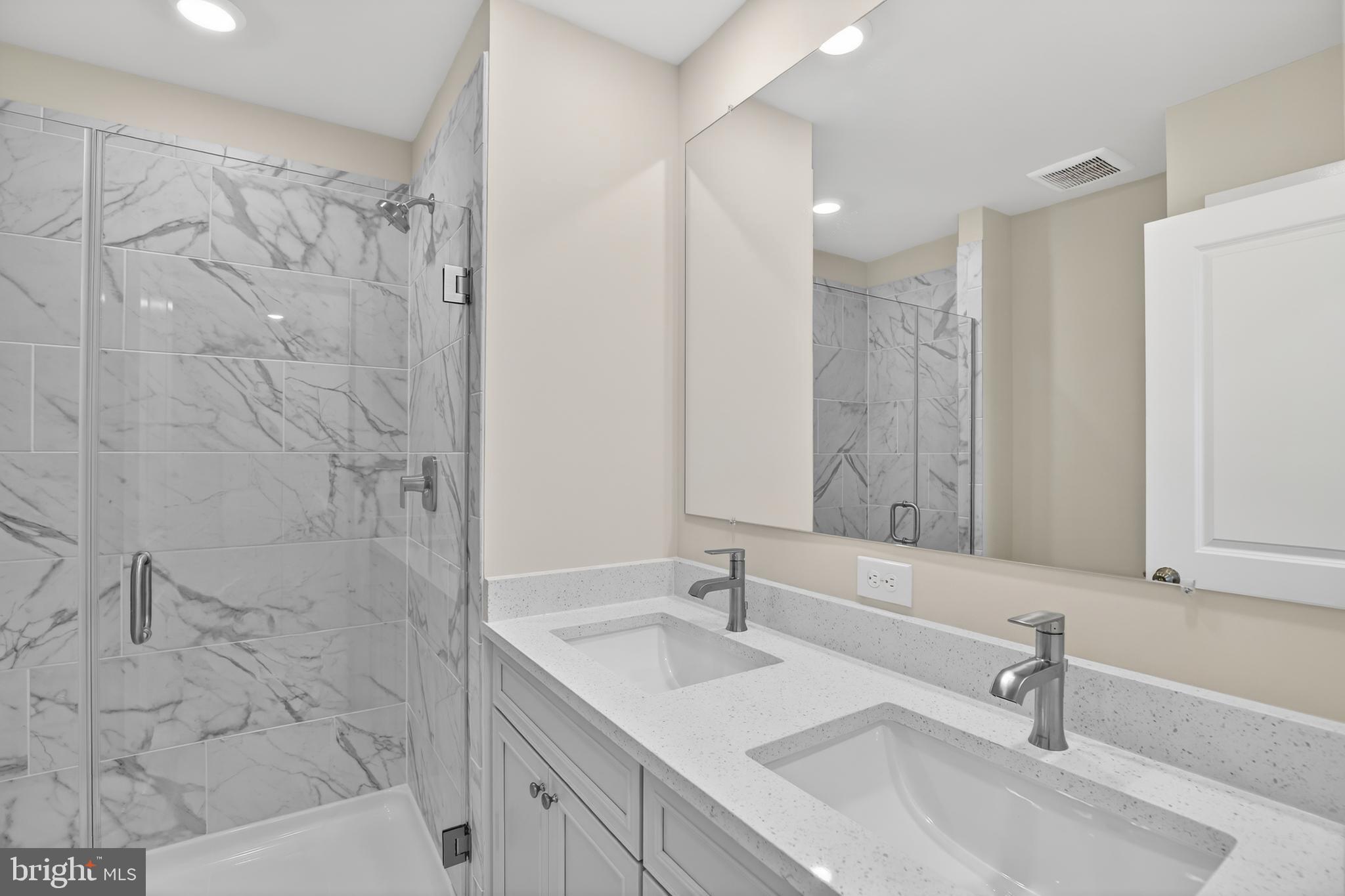 331 Hackley Drive Joppa, MD 21085 - Photo 12 of 18 a bathroom with a sink shower and a mirror