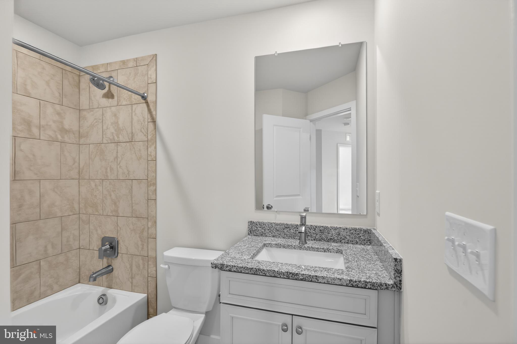 331 Hackley Drive Joppa, MD 21085 - Photo 16 of 18 a bathroom with a granite countertop sink and a mirror