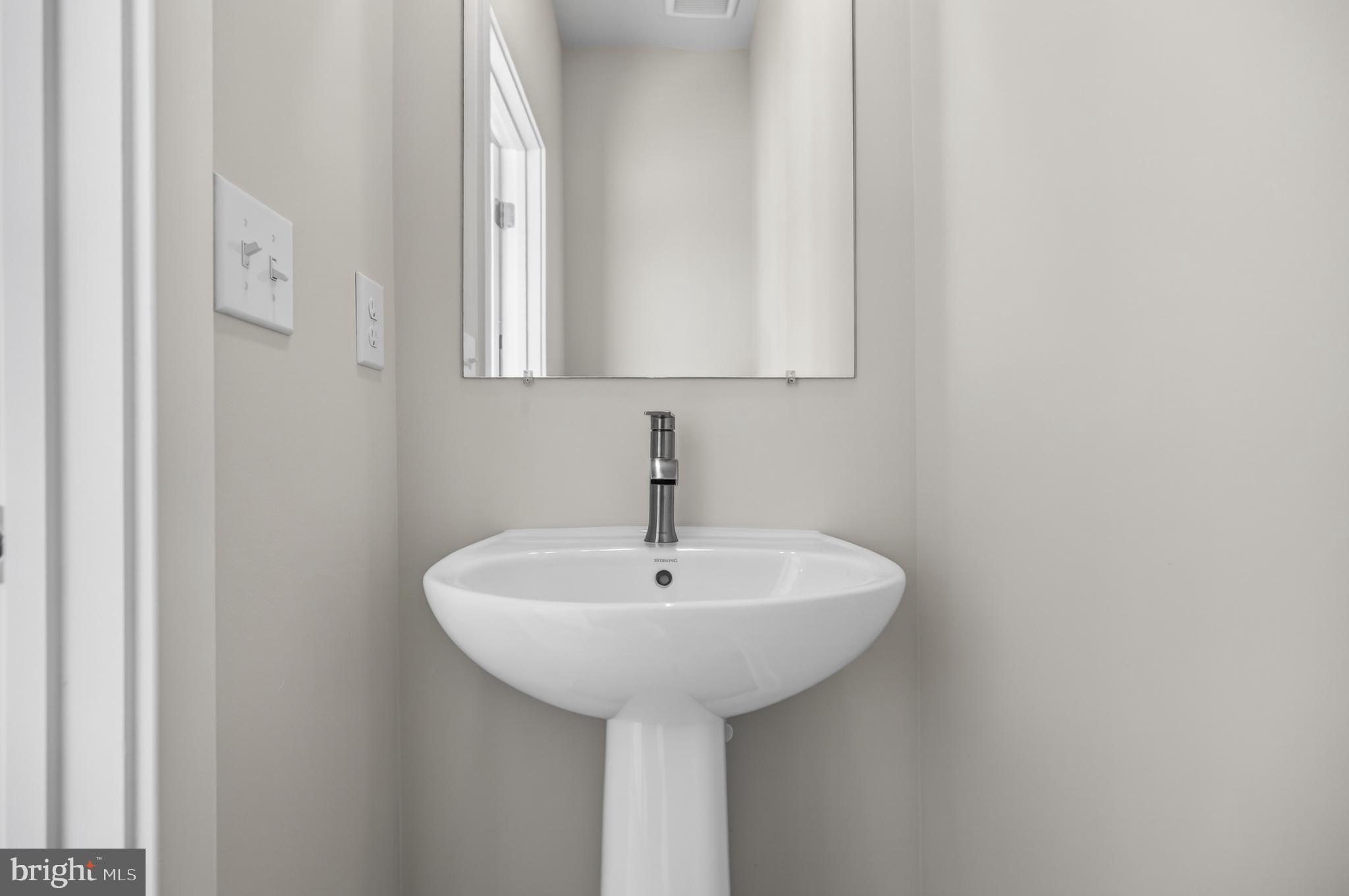 331 Hackley Drive Joppa, MD 21085 - Photo 17 of 18 a bathroom with a sink and a mirror