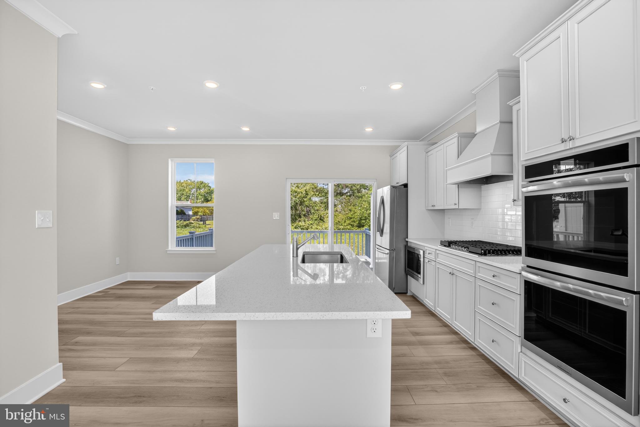 331 Hackley Drive Joppa, MD 21085 - Photo 4 of 18 a large kitchen with stainless steel appliances granite countertop a stove a sink and a microwave
