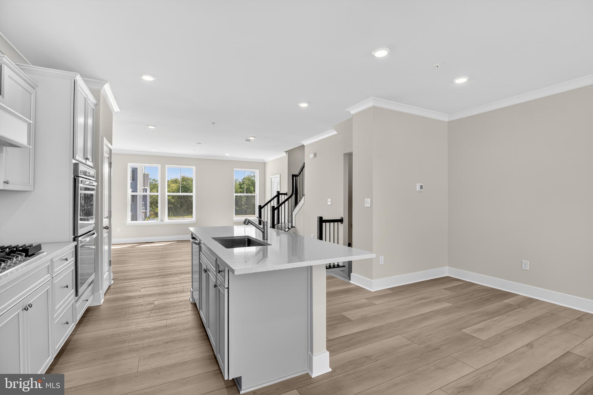 331 Hackley Drive Joppa, MD 21085 - Photo 5 of 18 a view of kitchen island wooden floor and living room