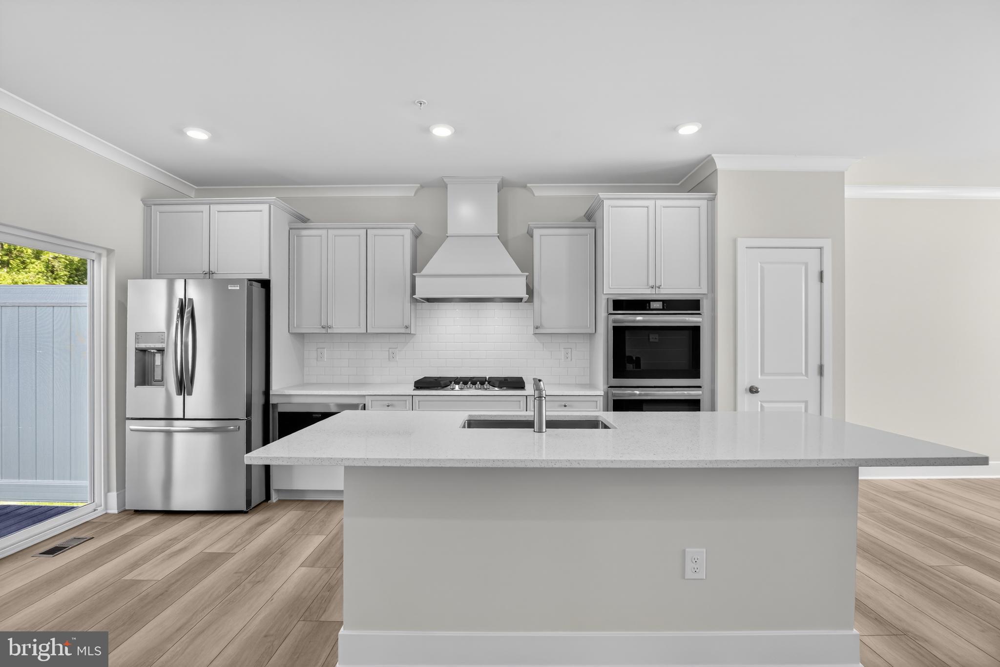 331 Hackley Drive Joppa, MD 21085 - Photo 7 of 18 a kitchen with kitchen island a white cabinets and refrigerator