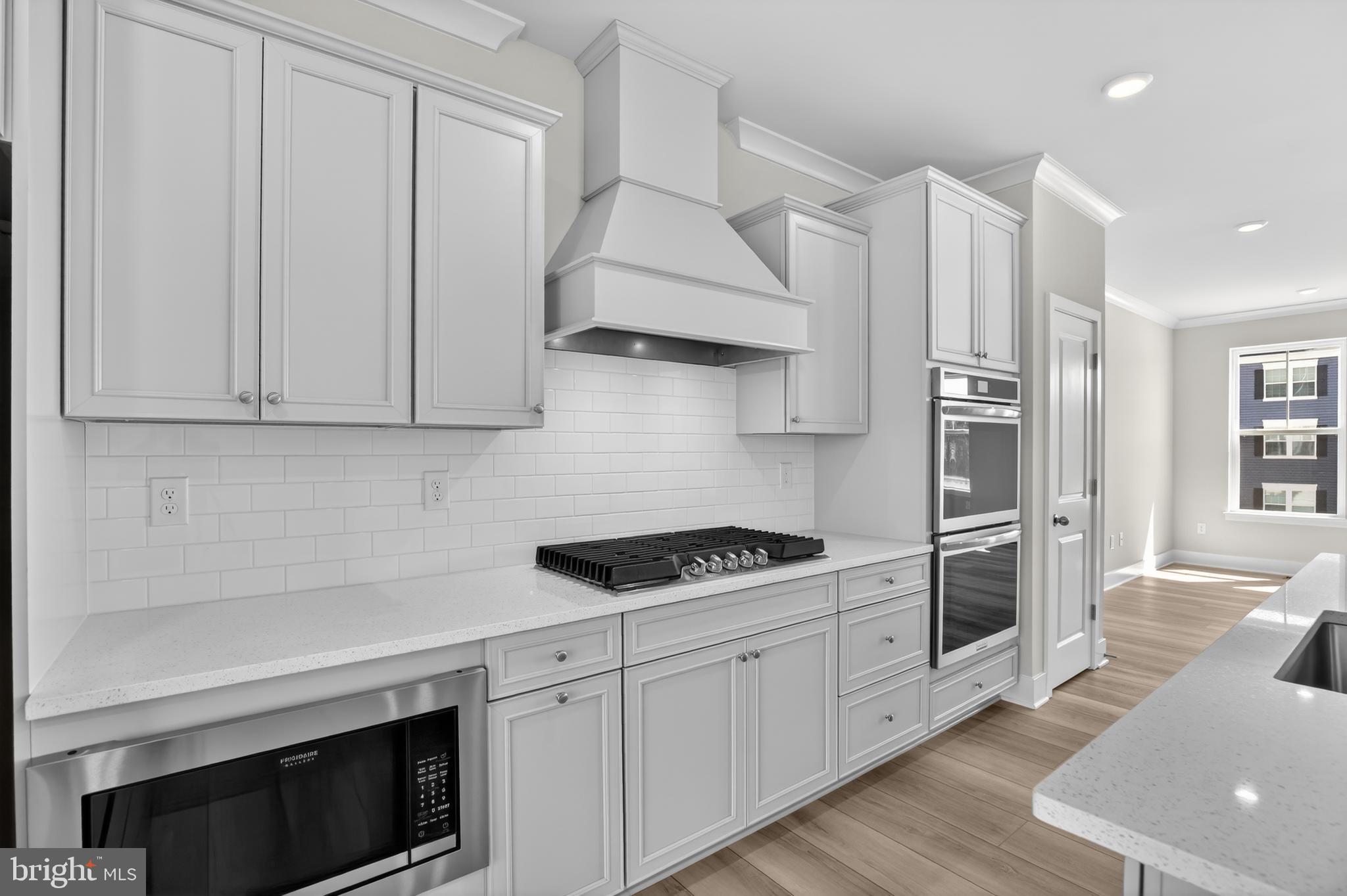 331 Hackley Drive Joppa, MD 21085 - Photo 8 of 18 a kitchen with stainless steel appliances white cabinets and a stove top oven