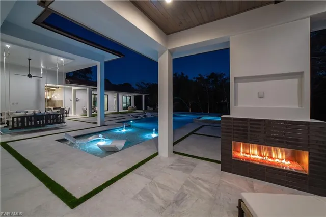 a living room with pool table and a couch