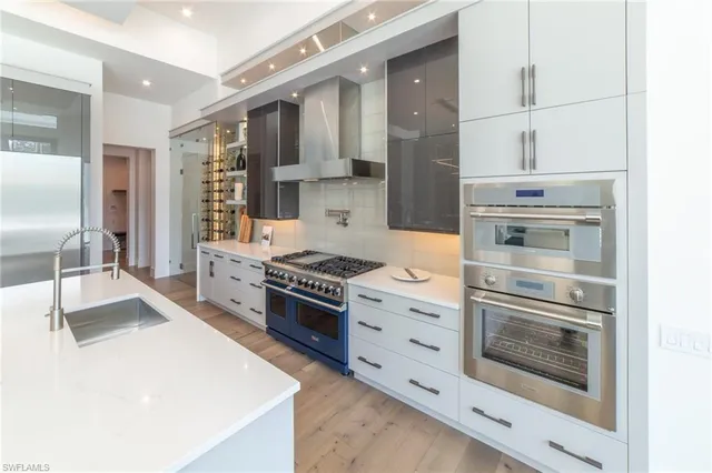 a kitchen with granite countertop a stove oven and a refrigerator