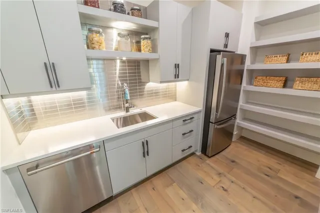 a kitchen with refrigerator and window