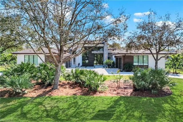 a front view of a house with a yard table and chairs