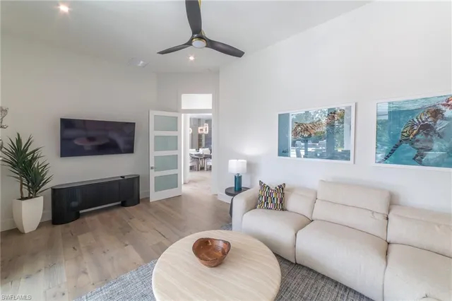 a living room with furniture and a wooden floor