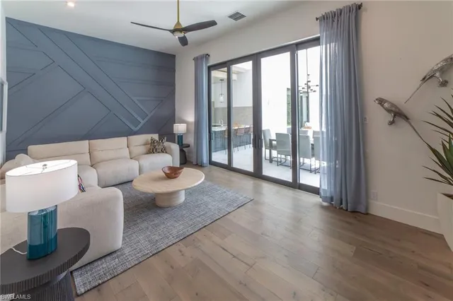 a living room with furniture and a potted plant