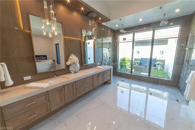 a bathroom with double vanity and a large mirror